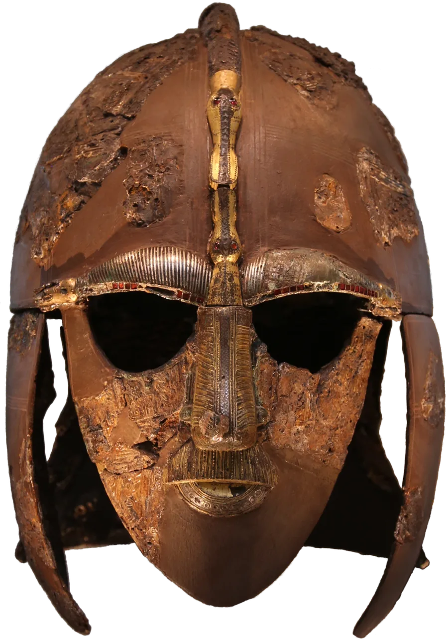 The Sutton Hoo helmet, front view: the corroded iron original reassembled from excavated fragments, its face-mask of inlaid silvery eyebrows and gilded nose and mustache joined by a dragon crest running over the crown, patches of stamped ornamental foil surviving on the cap.