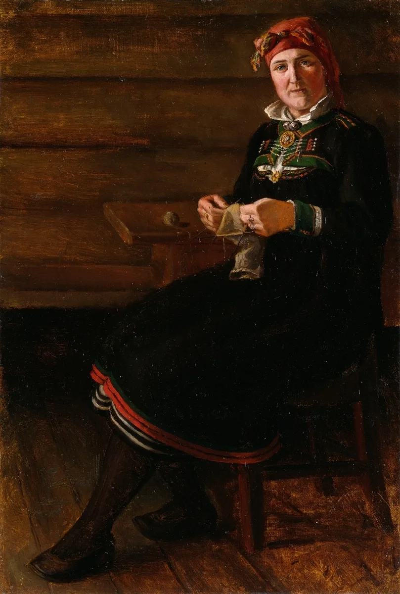 Painting of a woman seated in Setesdal folk costume — black bodice with a silver brooch and colorful embroidered panel, red headscarf, red-white-black striped apron band — knitting in a wood-cabin interior.