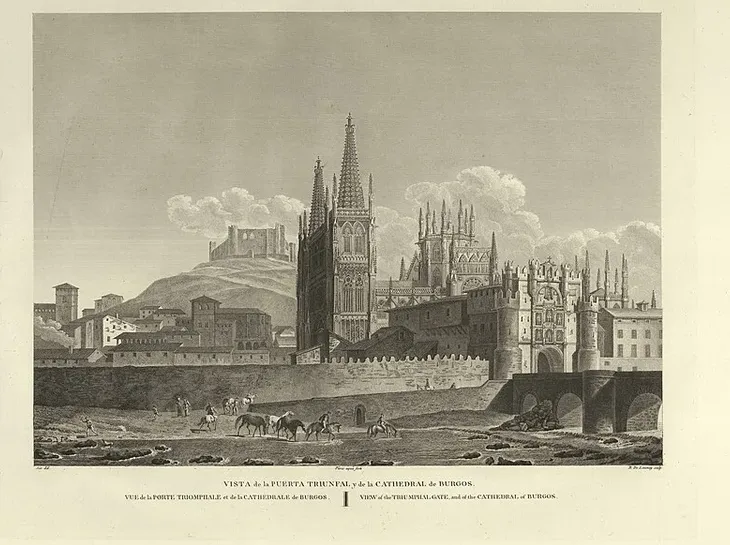 A sepia engraving titled 'Vista de la Puerta Triunfal y de la Cathedral de Burgos,' showing the spired Gothic cathedral and city walls on a hillside, with a stone bridge, riders, and horses in the foreground.