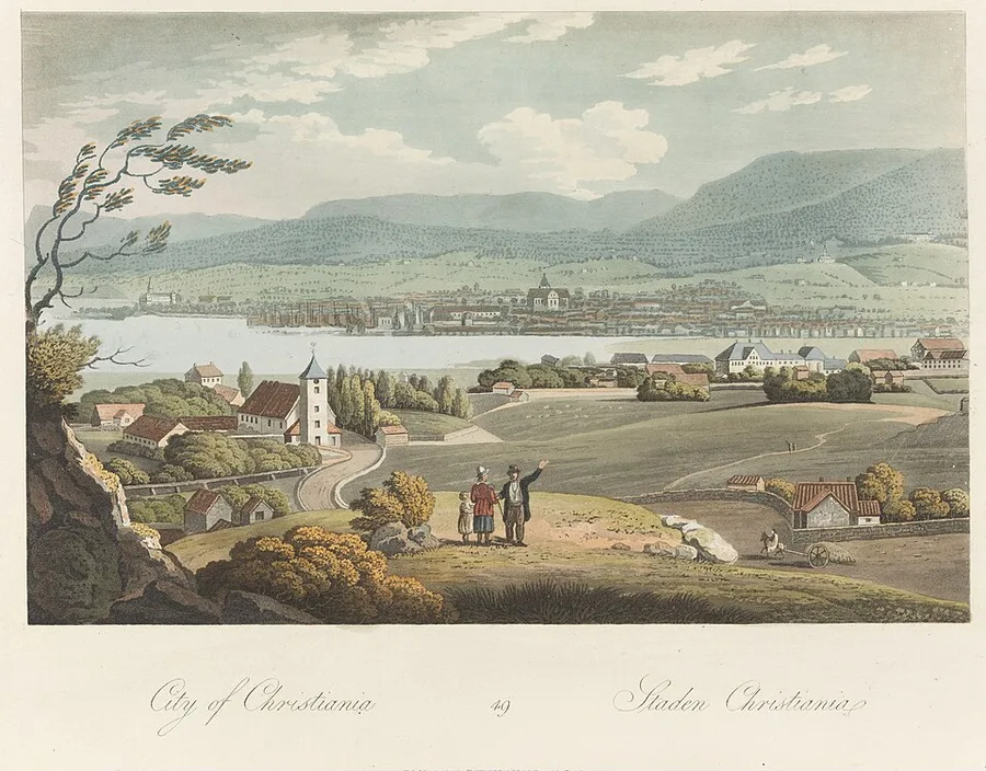 A hand-coloured 1814 aquatint of Christiania from across the water — the small grid-planned capital along the far shore under green hills, travellers pausing on a country road in the foreground.