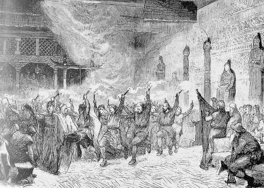 National-Romantic engraving of a torchlit hall: women in long robes and headscarves stand at center, one holding a large dark bowl, while men in tunics dance and leap around them waving lit torches; a harp player and a cloaked elder sit at right beside carved wooden pillars.