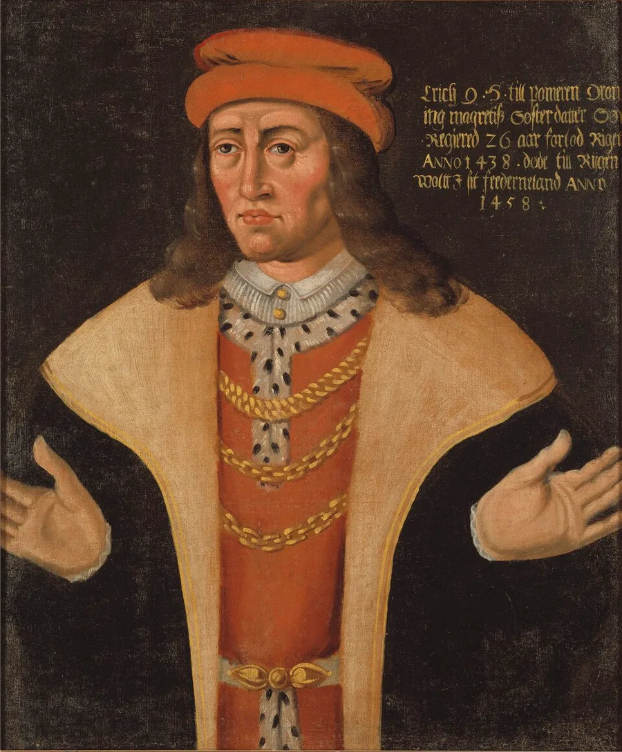 Half-length gallery portrait of King Erik of Pomerania in a red cap and cream fur-lined robe with gold chains, hands open at his sides, gold-lettered inscription naming him at upper right.
