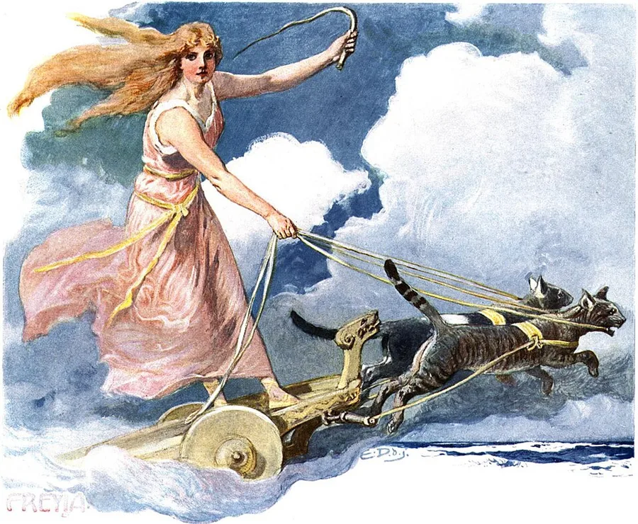 Emil Doepler's colour plate of Freyja from Walhall (c. 1905): the goddess in a rose gown with a golden sash, hair streaming, stands on a golden two-wheeled chariot with whip raised, driving two grey cats through clouds above the sea; 'FREYJA' is lettered in the lower left corner.