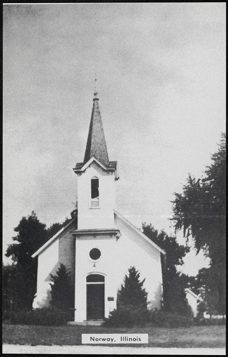 Halftone postcard photograph captioned 'Norway, Illinois': a white frame Lutheran church with a square belfry tower and slender spire, a round window above the arched door, and evergreens flanking the entrance.