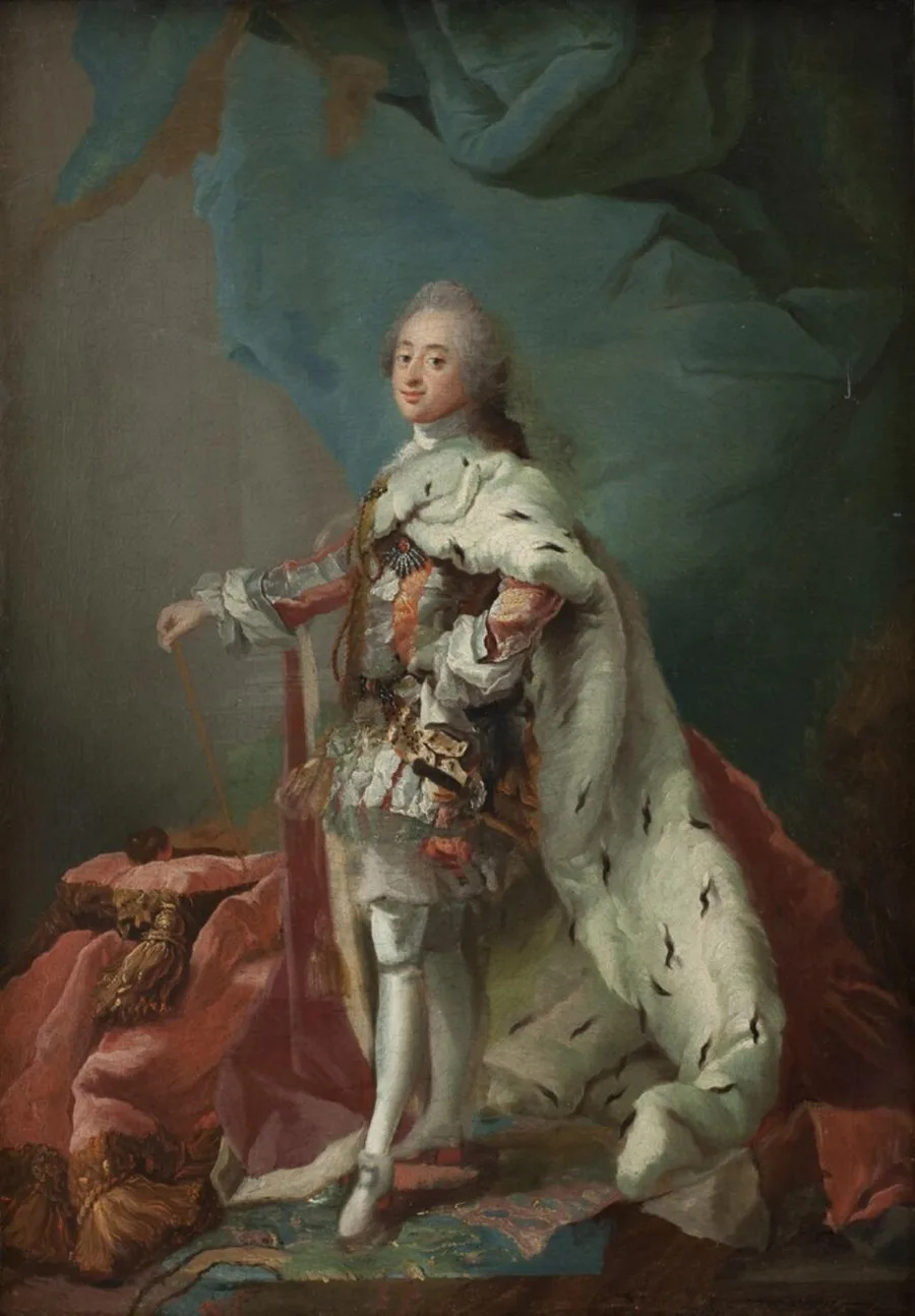 Full-length 18th-century state portrait of King Frederik V of Denmark-Norway in a powdered wig and ermine-lined coronation robe over armor, standing with a rod beside a red-draped cushion.