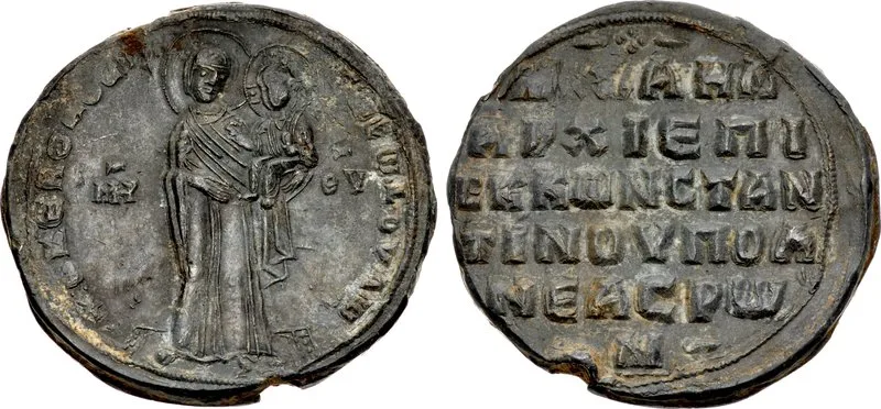 Photograph of both sides of a worn round lead seal (bulla) of Patriarch Michael Keroularios: the obverse shows two standing devotional figures in Byzantine style, the reverse is stamped with Greek lettering, against a plain white background.