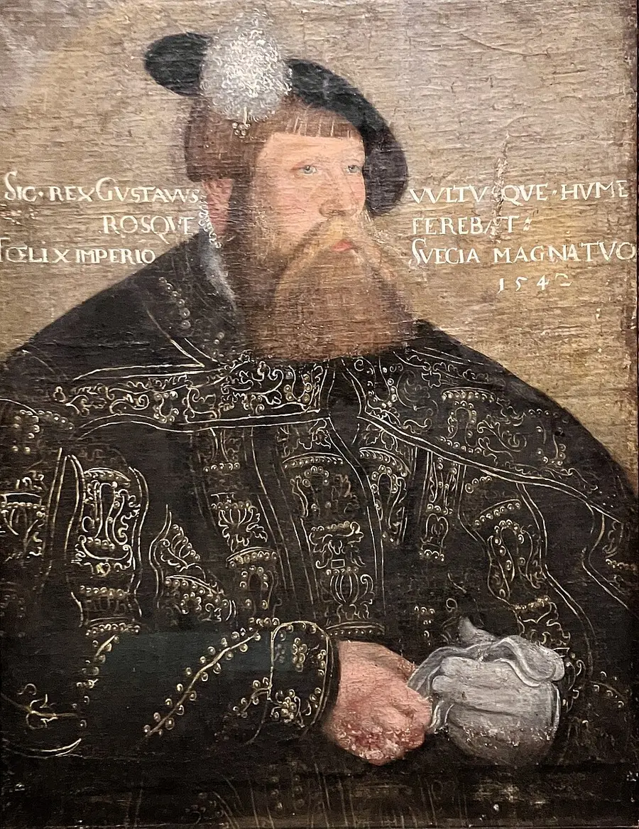 Close, half-length 16th-century portrait of King Gustav Vasa in a fur-trimmed black cap and dark bejeweled robe with gold embroidery, a Latin inscription beside his head.