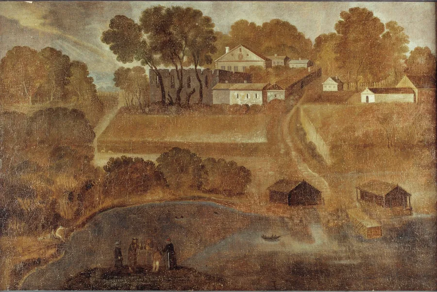 1656 oil painting of Halsnøy monastery: the arched ruin of the medieval church stands among trees beside white-plastered buildings on a hilltop, a road running down between fenced fields to boathouses at the water, where small figures gather on a knoll.