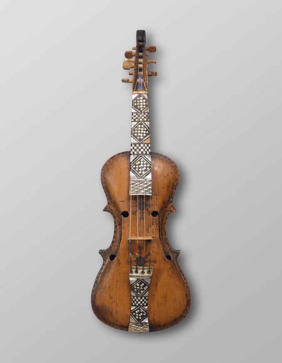 The Jaastad fiddle of 1651, the oldest surviving Hardanger fiddle — dark-bodied with checkered inlay and mother-of-pearl down the fingerboard and tailpiece, at the University Museum of Bergen.