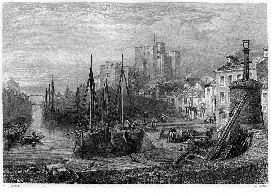 A mid-19th-century engraving of Castle Rushen rising over Castletown harbour on the Isle of Man, with masted sailing vessels moored at the quay, small rowboats on the water, and dockworkers and carts in the foreground.