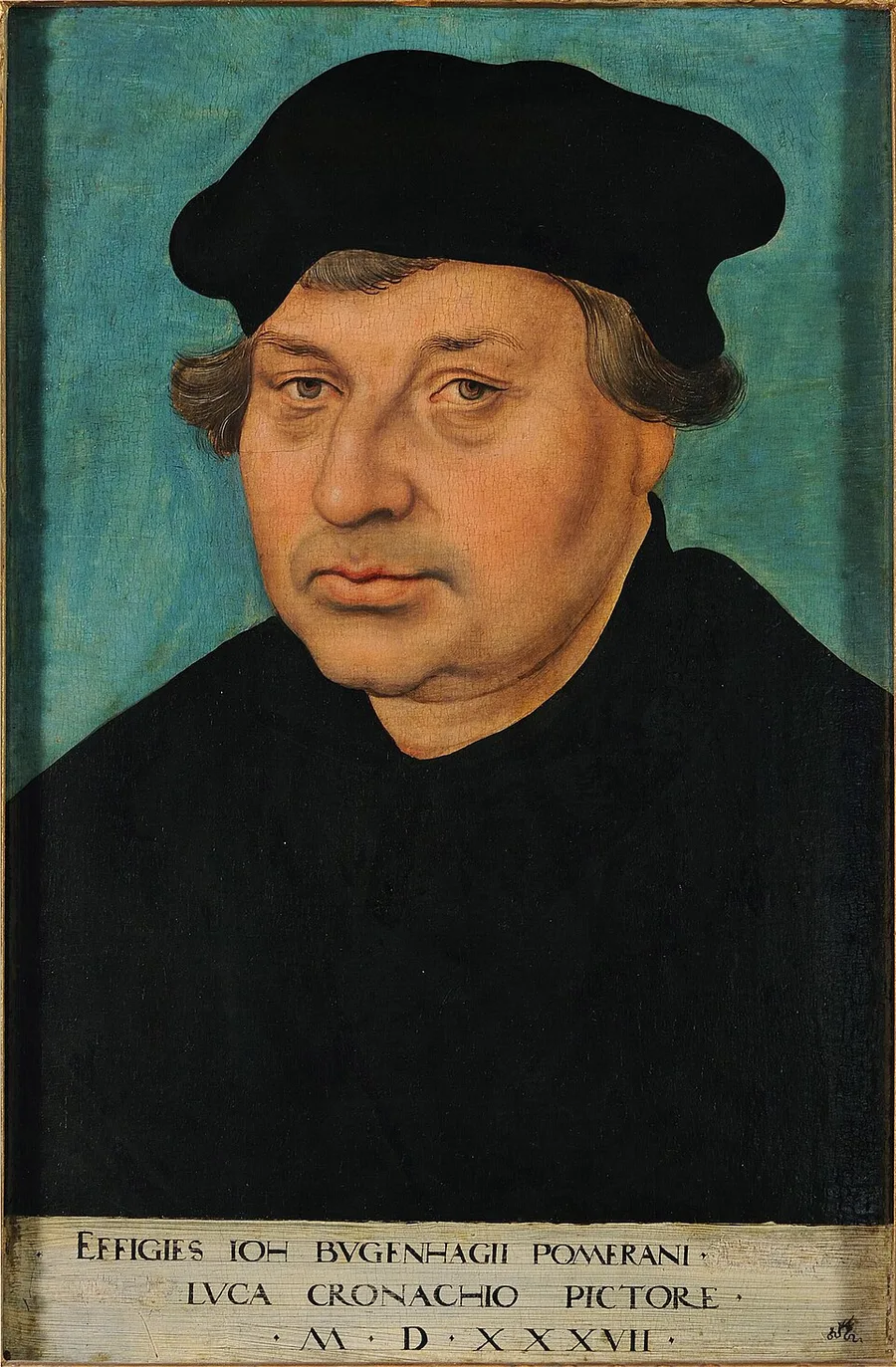 Half-length portrait of Johannes Bugenhagen, an older balding man with gray hair and a black beret, in a plain black robe with no collar, against a teal-blue background; a Latin inscription band naming him and dated 1537 runs along the bottom.