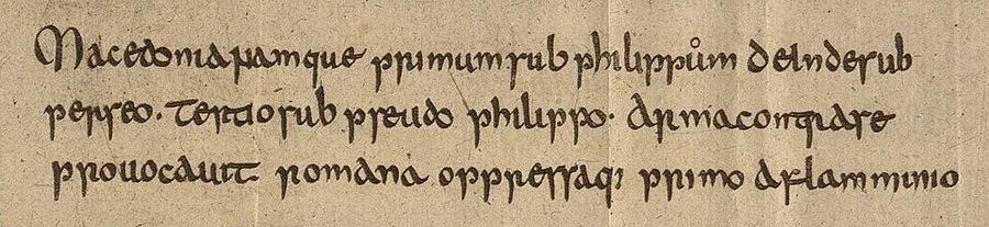 Three lines of early medieval Latin minuscule on toned paper — a facsimile specimen from the Heidelberg codex of Jordanes, engraved for Friedrich Wilken's 1817 catalogue; the visible passage names Macedonia, Philip and Perseus.