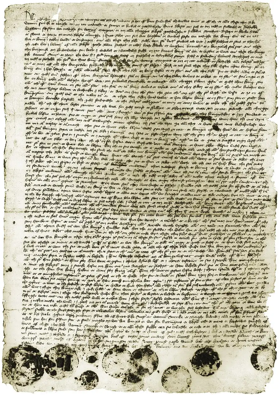 A photograph of the 1397 Kalmar Union letter: a full parchment page densely covered in medieval script, its ragged lower edge hung with a row of dark, worn wax seal impressions.
