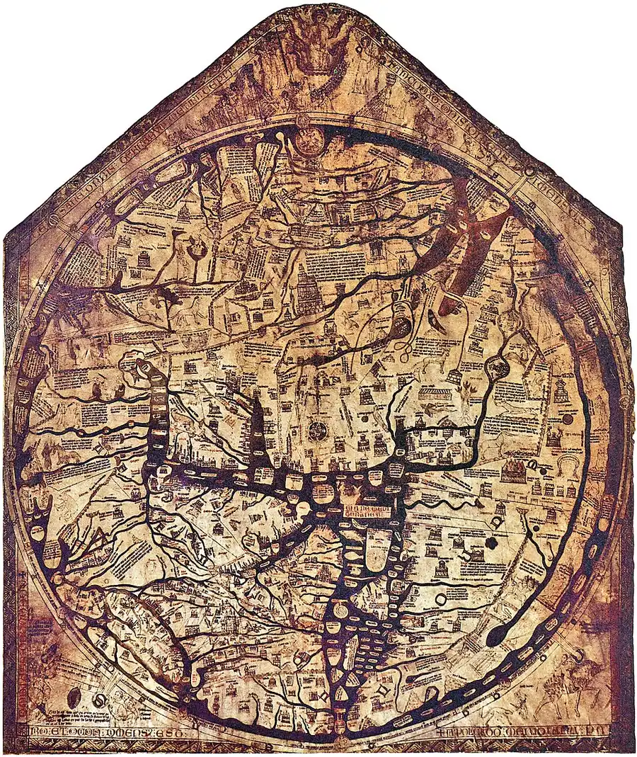 A tall, pointed-topped medieval world map covering full parchment, near-circular, packed edge to edge with tiny brown-ink drawings of walled cities, rivers, and mountains, dense blocks of labels radiating out from a crowded center.