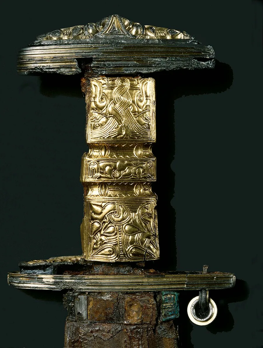 The gilded hilt of the Snartemo sword, c. 500 CE — gold-wrapped grip and pommel worked with dense Migration-Period animal ornament, from a chieftain's grave in Vest-Agder.