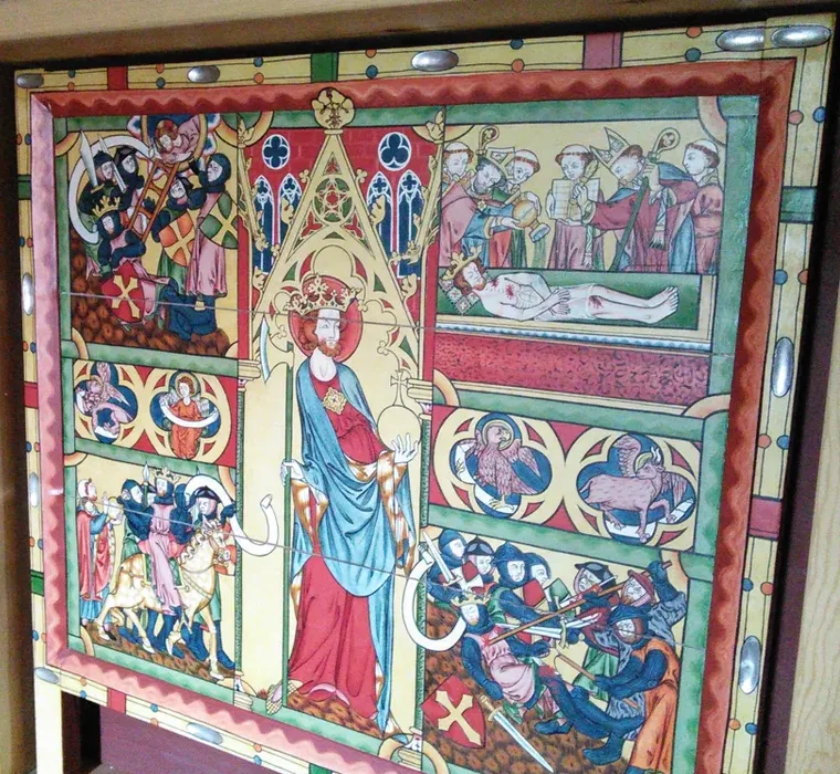 Photograph of a full-scale replica of the Olav Altar Frontal: a gilded panel in four registers showing armed men at Olav's death, his body laid out, roundels of an eagle and griffin, and Olav crowned and enthroned at center with sword and orb.