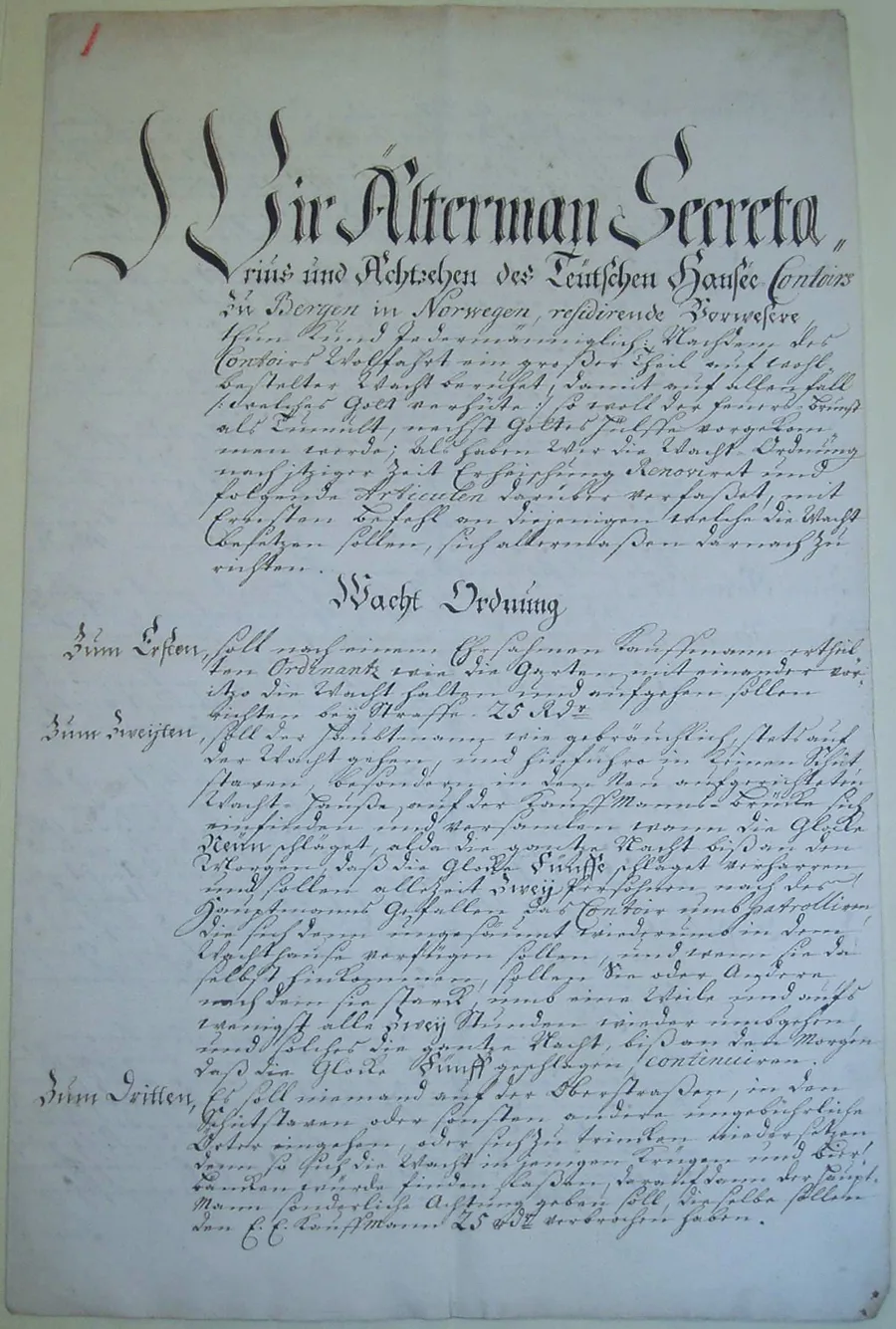 Handwritten German document of 1704 with a giant calligraphic opening line, a centered heading "Wacht Ordnung," and numbered articles — Zum Ersten, Zum Zweiten, Zum Dritten — threatening fines in riksdaler.