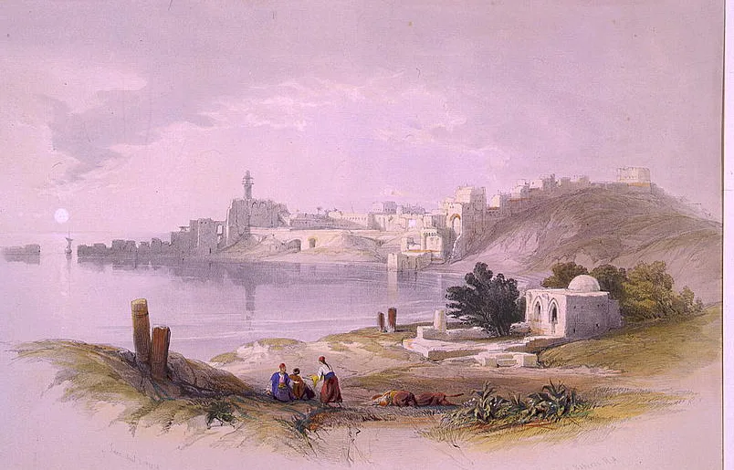 Tinted lithograph view across a calm bay to Sidon on its low promontory, its castle crowning the hill at right; a domed shrine and seated figures rest on the sandy foreground shore under a pale moonlit sky.