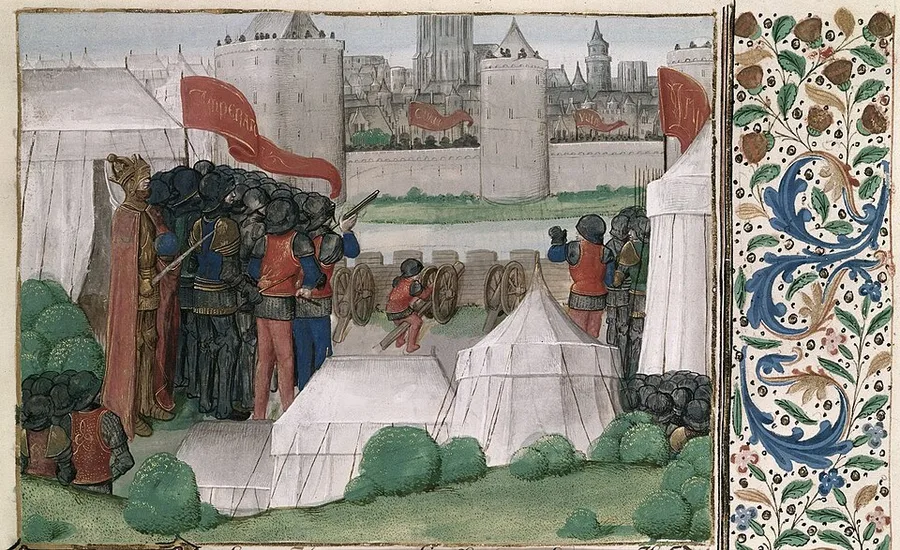 A manuscript miniature: white crusader tents in the foreground beside cross-marked red banners, soldiers aiming wheeled siege engines at a walled, turreted coastal city under assault, with a floral-and-acorn decorative border along the right edge.